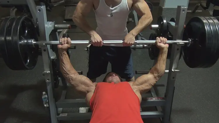 guy bench pressing in gym