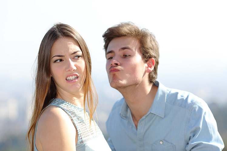 girl rejecting guys kiss bad sign
