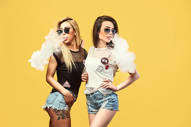 two pretty girls vaping